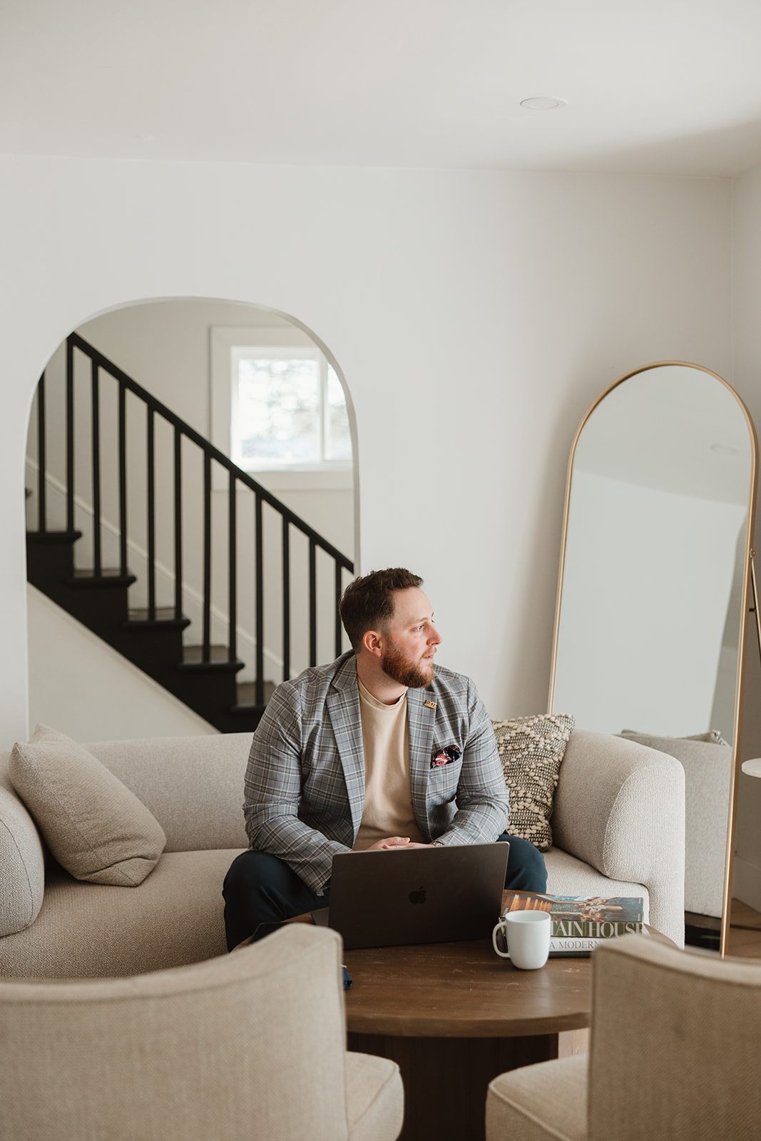 Founder working on laptop near staircase