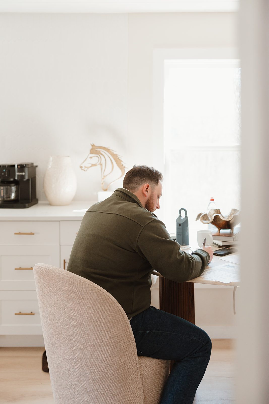 Founder writing notes at desk