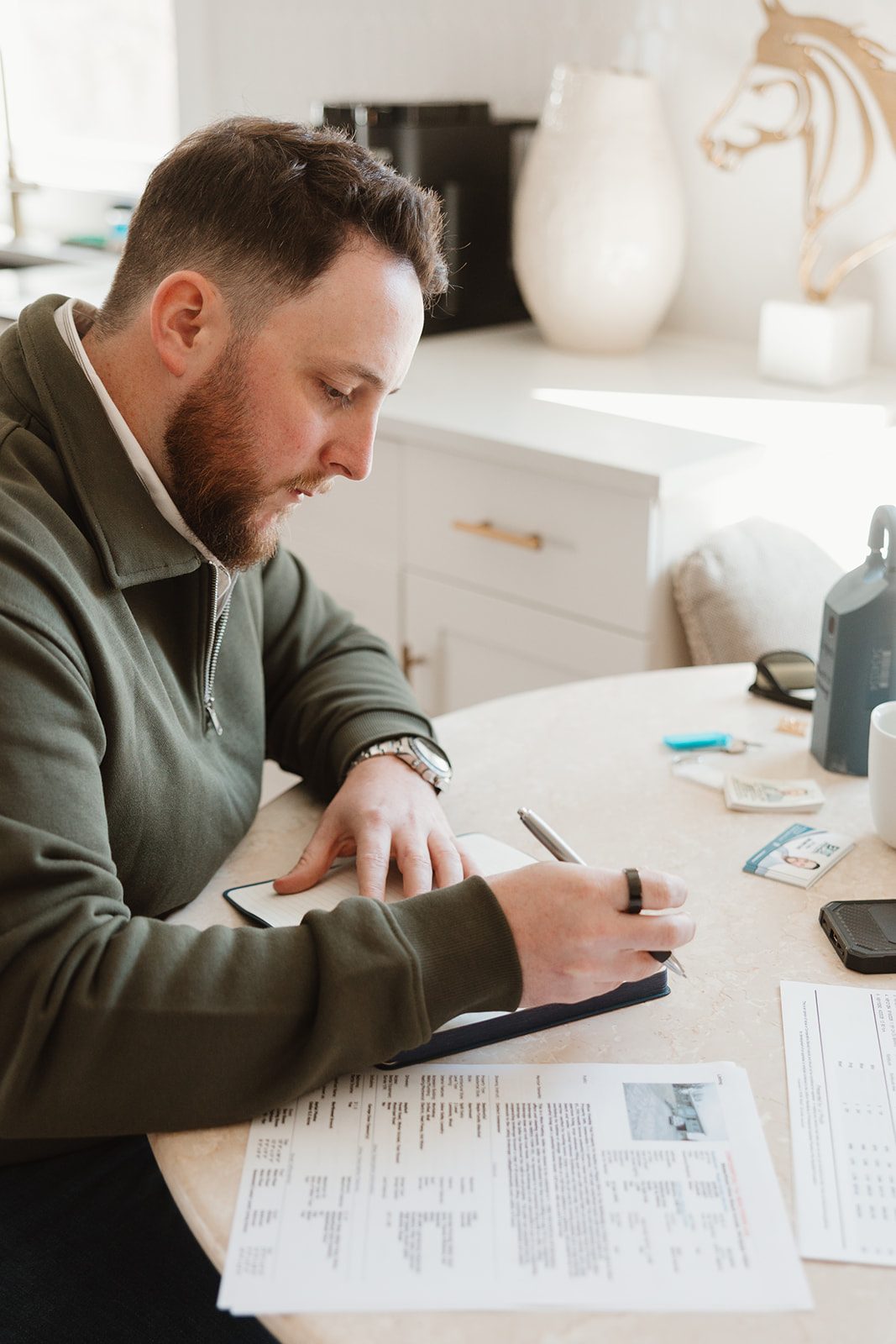 Founder writing notes, close angle