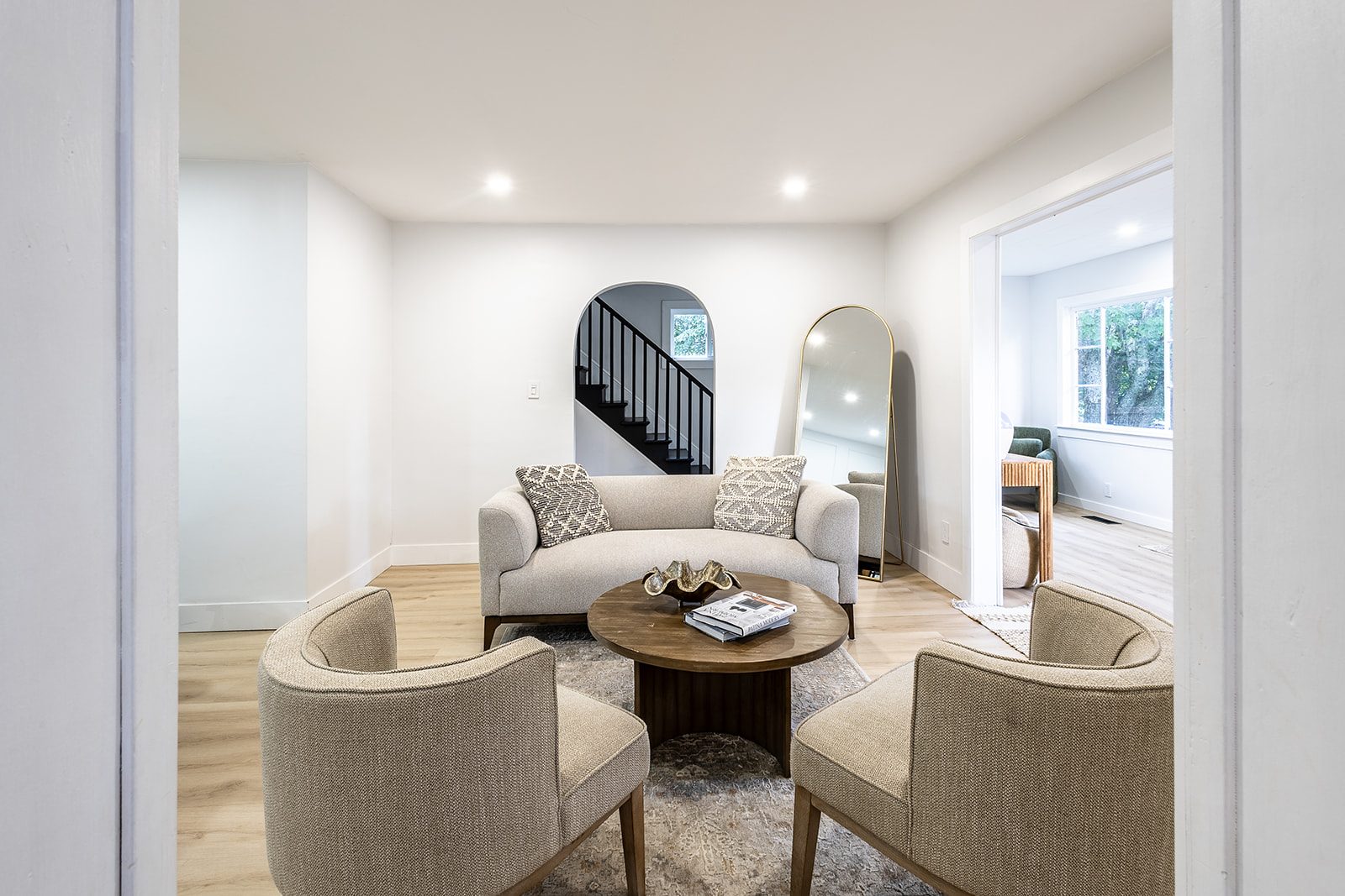 Living room with staircase archway